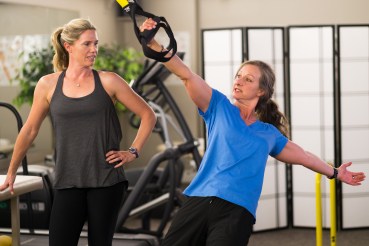 Jewel provides fitness instruction to client